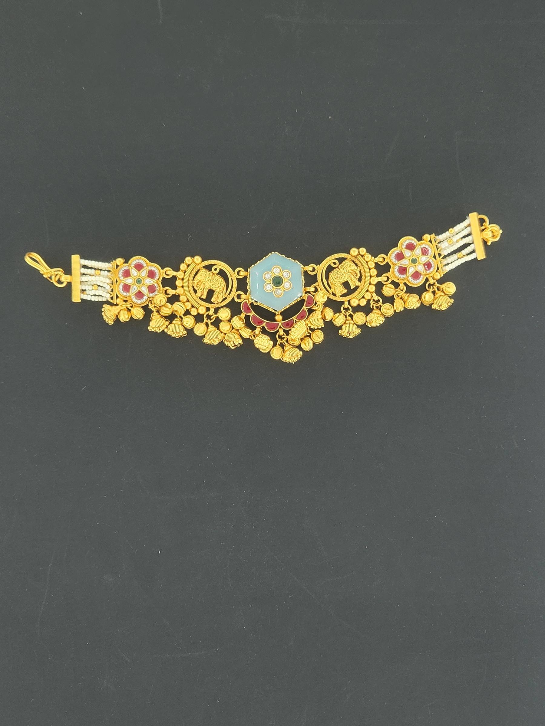 Gold bracelet with powder-blue six-sided centre, elephant motifs, red and white flowers, bead drops and pearl strands