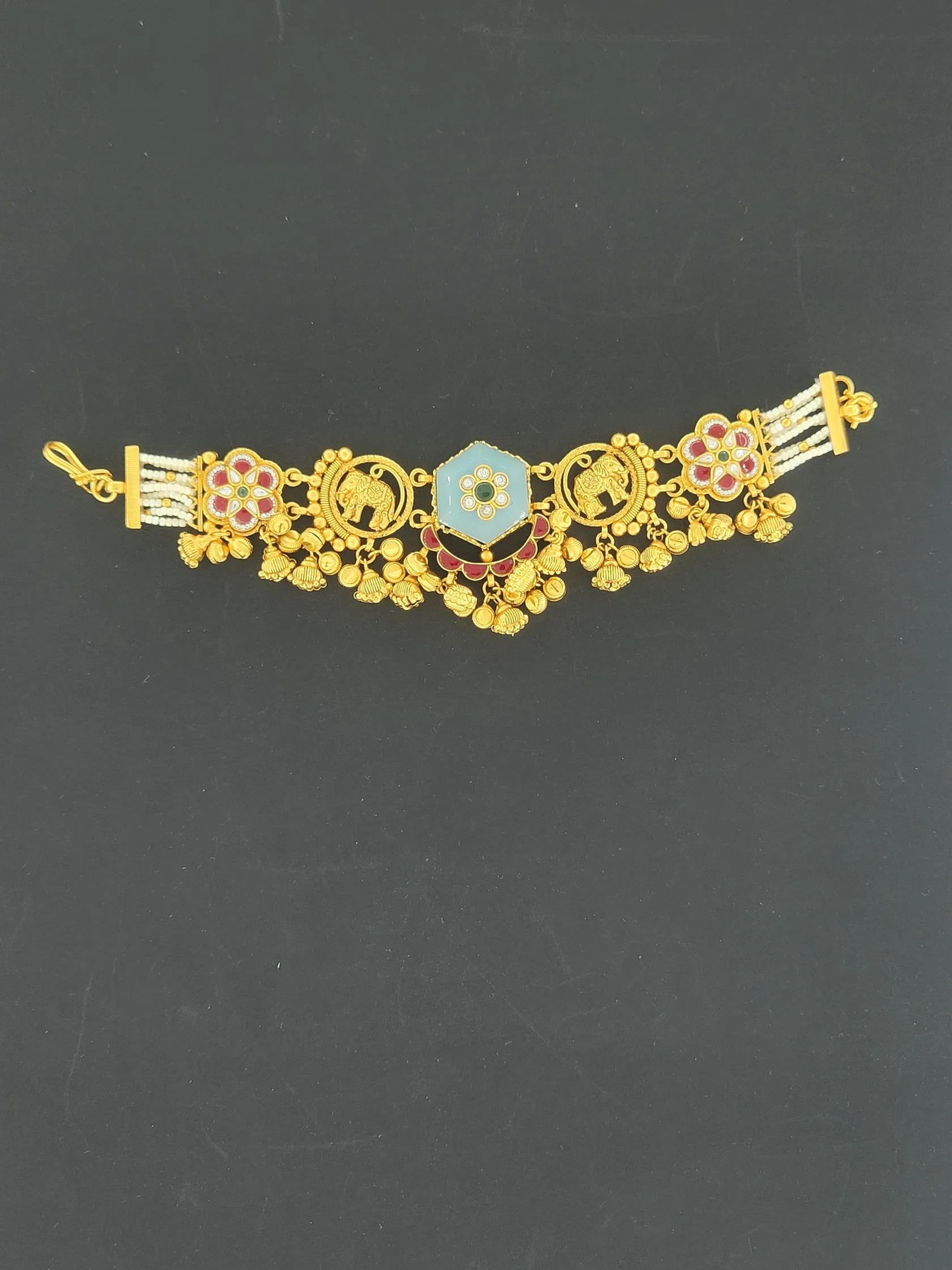 Gold bracelet with powder-blue six-sided centre, elephant motifs, red and white flowers, bead drops and pearl strands