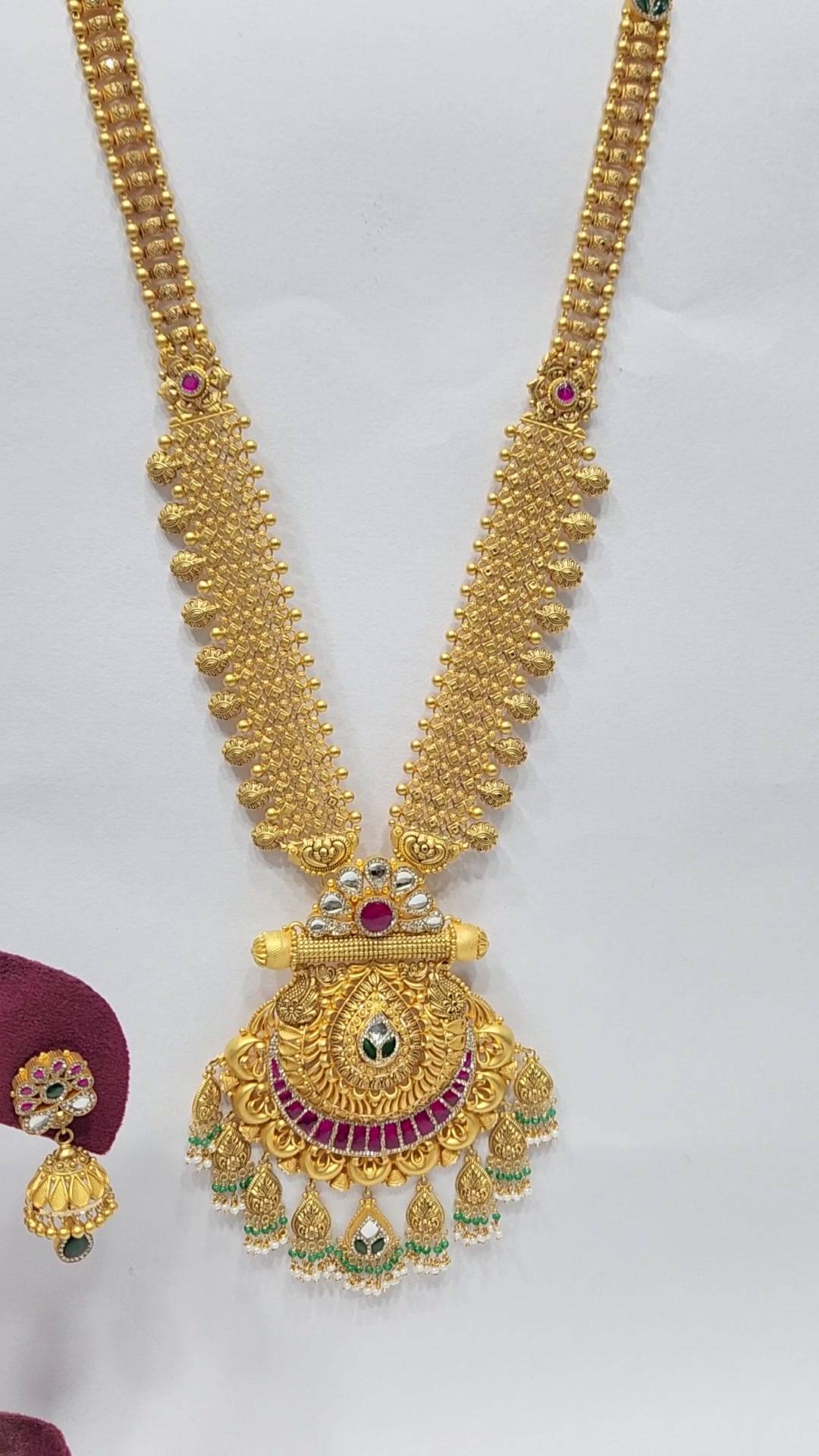 Long gold haram with twin bead strands, ruby-red stone crescent pendant and green and pearl-bead drops